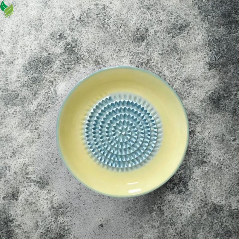 Ceramic grater plate with colorful rim and textured grinding center
