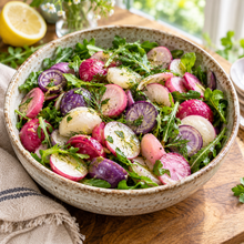 Colorful Easter Egg radishes growing in a raised garden bed.