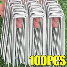 turf anchoring pins installation with hammer