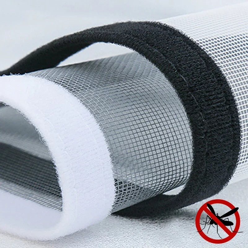 Close-up of black window screen attachment tape with white backing peeled away.