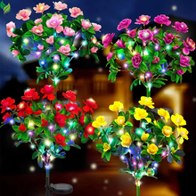 Solar LED azalea flower garden stake lights glowing at night