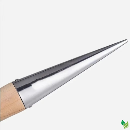hand using seed dibber in vegetable garden