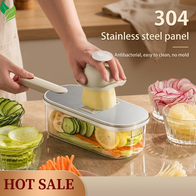 Multi-function vegetable cutter slicing cucumber and potato into a clear container