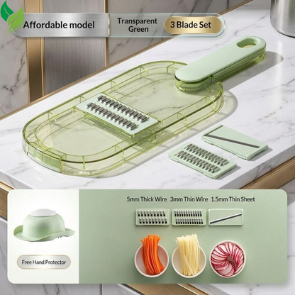 Transparent green vegetable slicer with three removable blade inserts